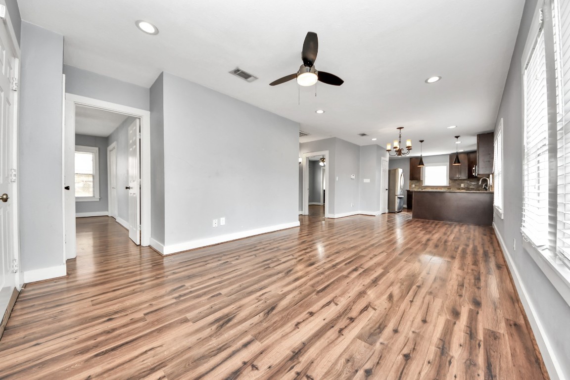 2820 Holman Street Houston, TX 77004 - Photo 12 of 38 a view of a living room with wooden floor and a kitchen
