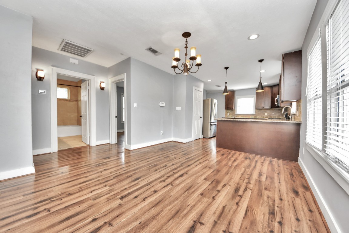 2820 Holman Street Houston, TX 77004 - Photo 13 of 38 a view of a kitchen with wooden floor and a kitchen