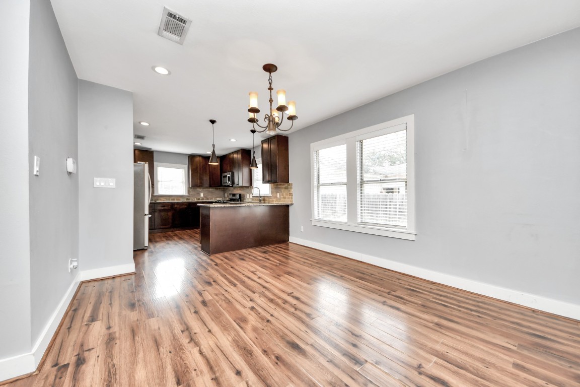 2820 Holman Street Houston, TX 77004 - Photo 14 of 38 a view of a kitchen with wooden floor and a kitchen