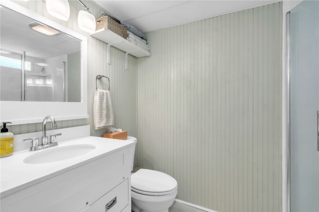 506 Charlies Creek Road Iva, SC 29655 - Photo 19 of 28 A well-lit bathroom with white vanity and integrated sink, offering practicality and clean lines.