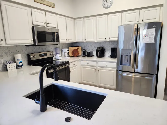 a kitchen with a refrigerator sink and microwave