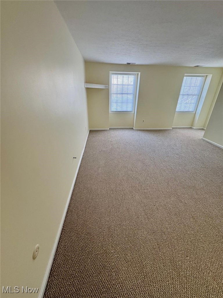 17073 Drake Road Strongsville, OH 44136 - Photo 23 of 50 Carpeted spare room featuring baseboards and a textured ceiling