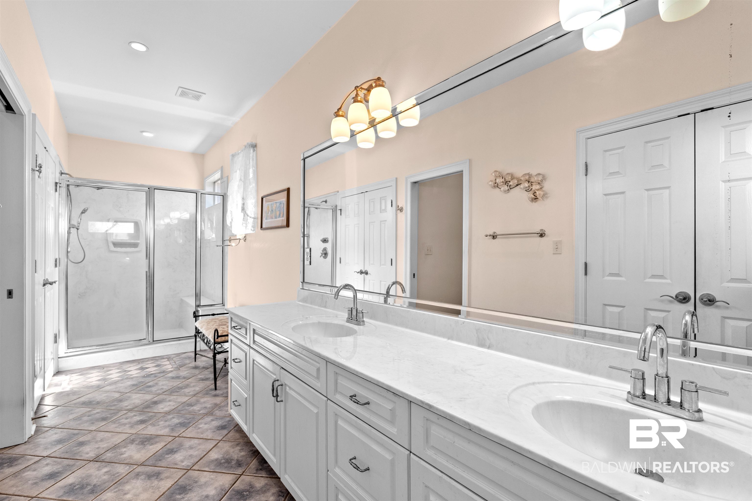 237 Hemingway Loop Foley, AL 36535 - Photo 16 of 49 Bathroom with a sink, double vanity, a shower stall, and tile patterned flooring
