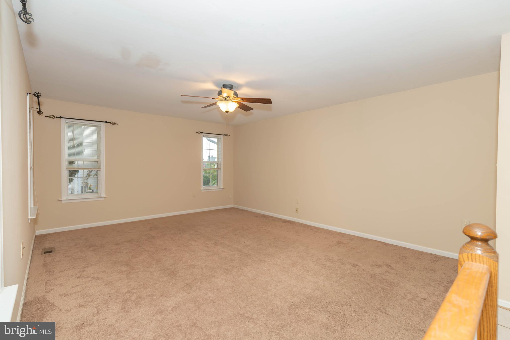 131 Cypress Point Drive Charles Town, WV 25414 - Photo 11 of 35 an empty room with windows and chandelier fan