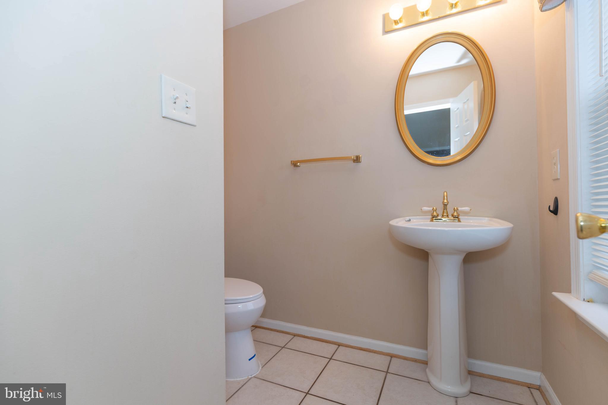 131 Cypress Point Drive Charles Town, WV 25414 - Photo 12 of 35 a bathroom with a sink toilet and a mirror