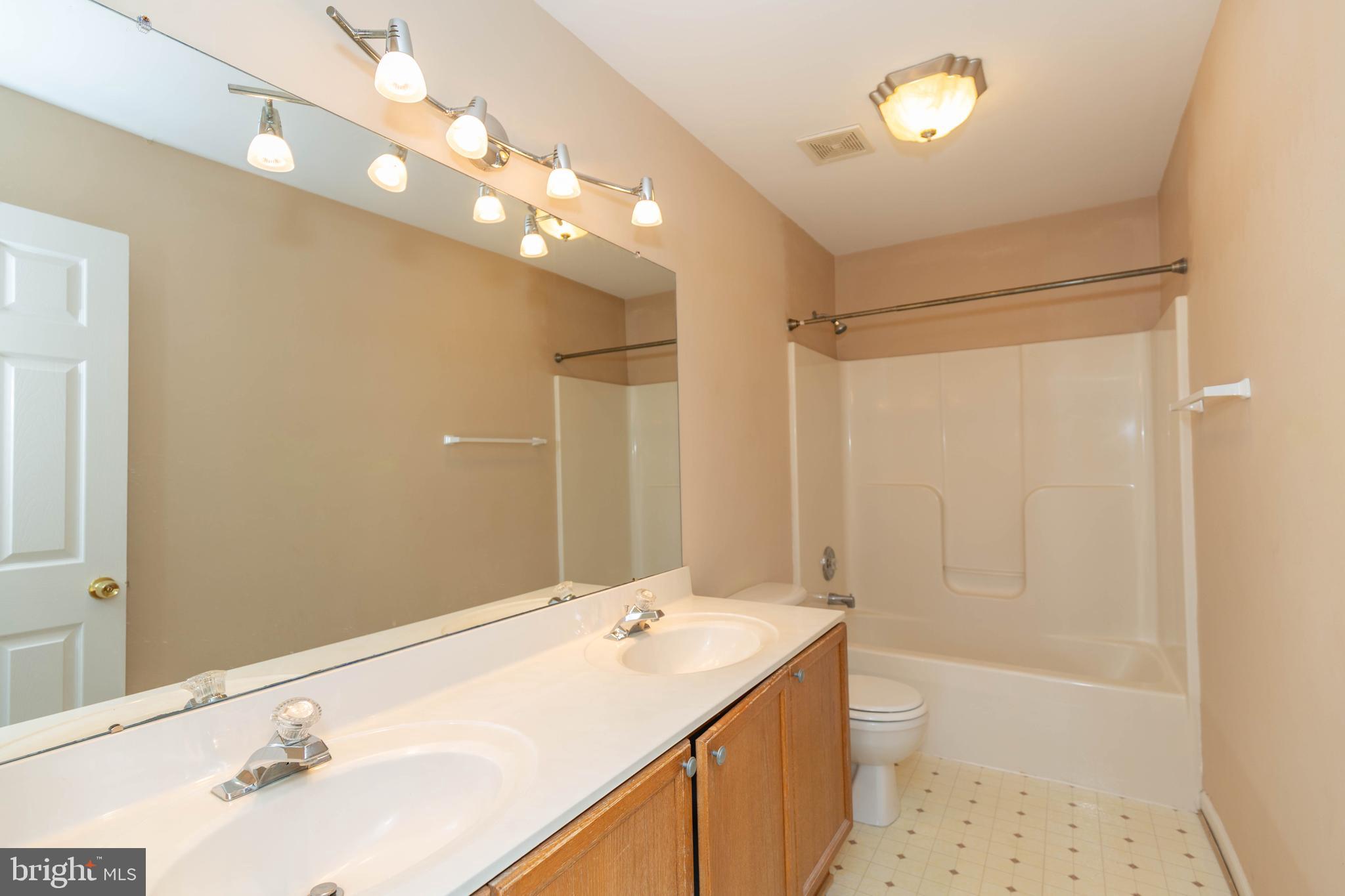 131 Cypress Point Drive Charles Town, WV 25414 - Photo 20 of 35 a bathroom with a sink a toilet and shower