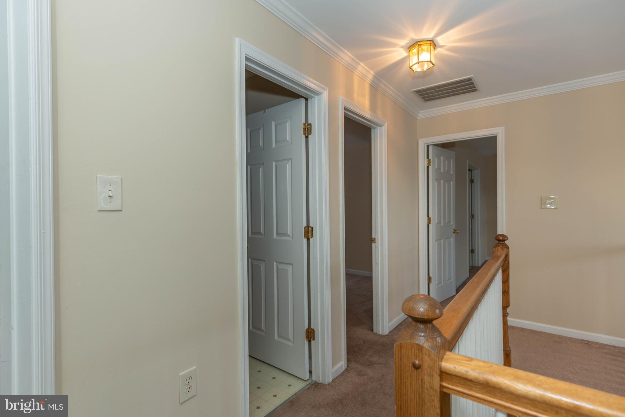 131 Cypress Point Drive Charles Town, WV 25414 - Photo 25 of 35 a view of a hallway with wooden floor and staircase