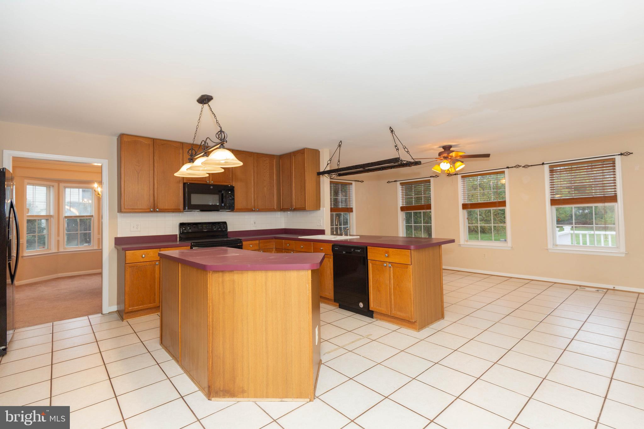 131 Cypress Point Drive Charles Town, WV 25414 - Photo 7 of 35 a kitchen with stainless steel appliances granite countertop a stove a sink and a microwave