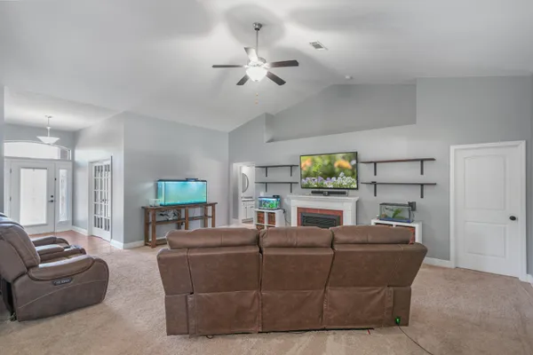 a living room with furniture and a fireplace