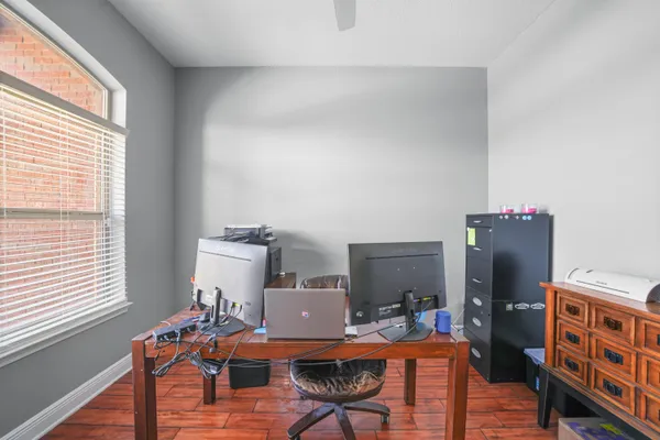 a view of a workspace with furniture and a window