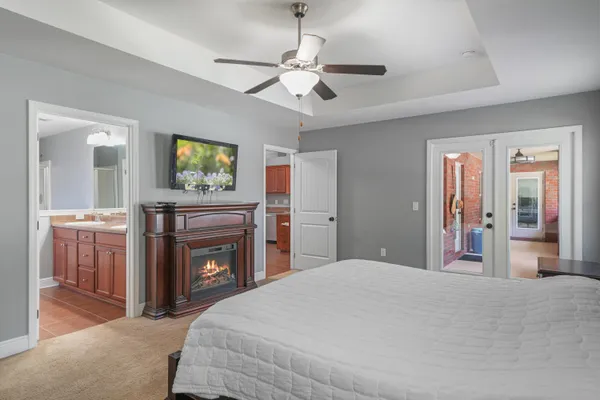 a bedroom with a large bed and a fireplace