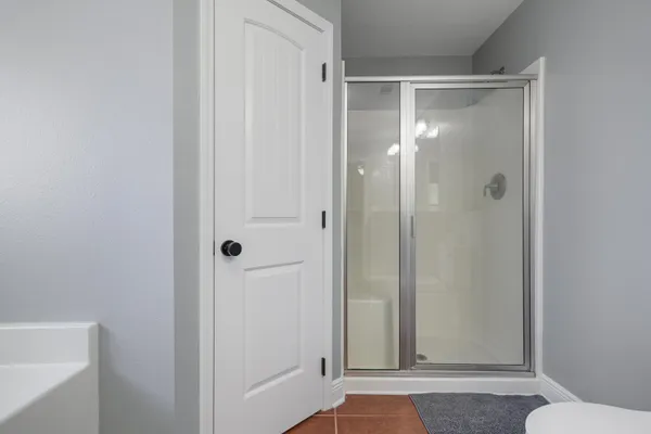 a bathroom with a glass shower door