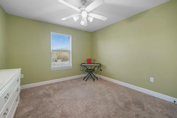 a bench sitting in a room next to a window