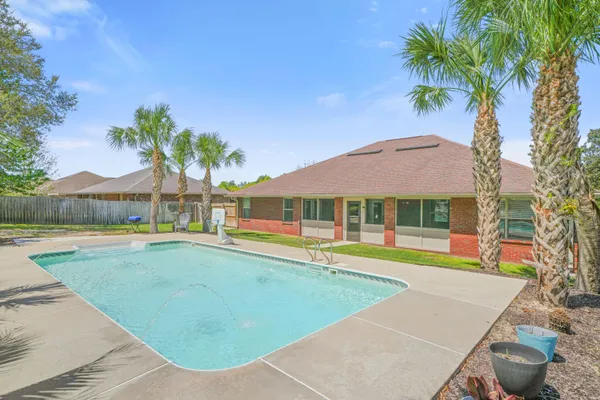 a view of pool with umbrella and lake view