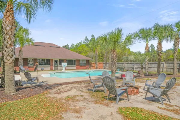 a backyard of a house with table and chairs