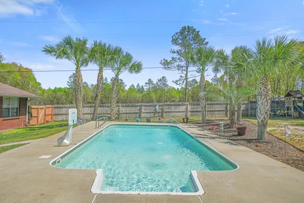 a view of a swimming pool with a yard
