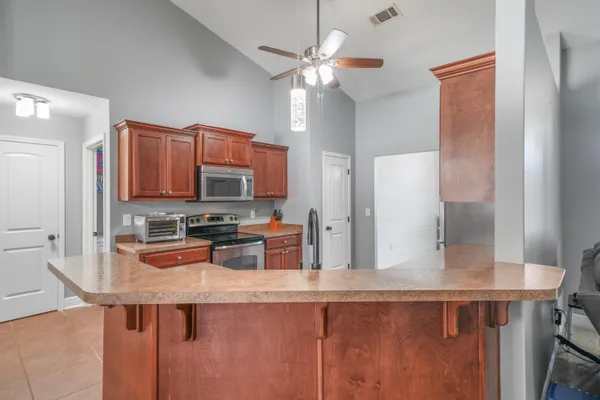 a kitchen with stainless steel appliances granite countertop a sink refrigerator and microwave