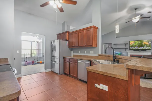 a kitchen with a sink appliances and cabinets