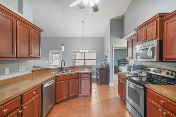 a kitchen with stainless steel appliances granite countertop a sink stove and refrigerator