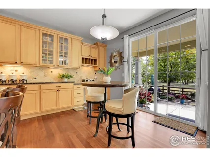 a kitchen with sink a window and chairs