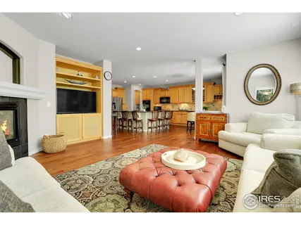 a living room with furniture a rug and a large window
