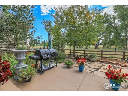 a view of a patio with table and chairs and potted plants