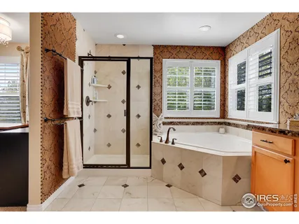 a bathroom with a granite countertop sink toilet a mirror and shower