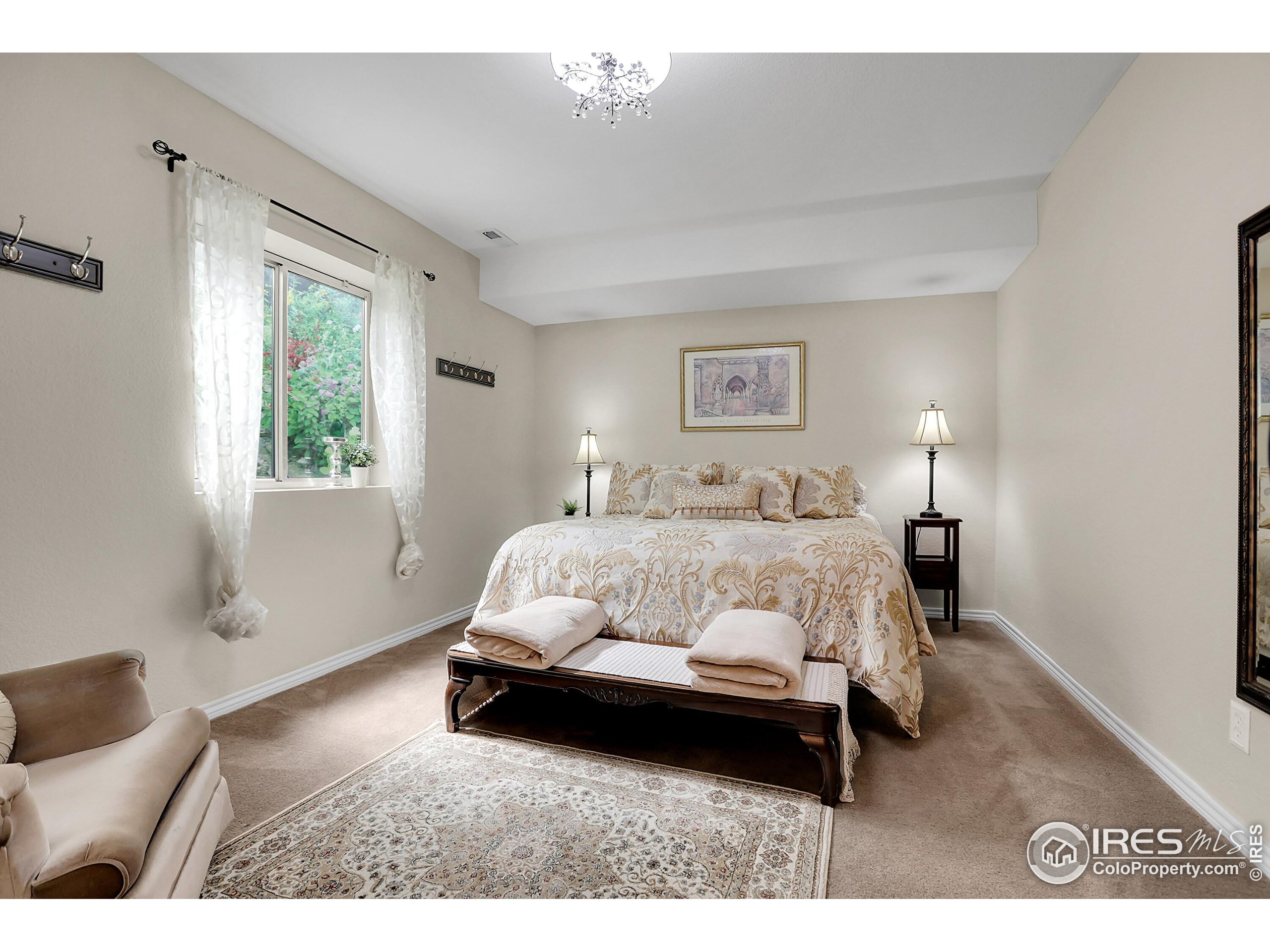 112 Austin Avenue Erie, CO 80516 - Photo 38 of 44 a bedroom with a bed lamp and a window