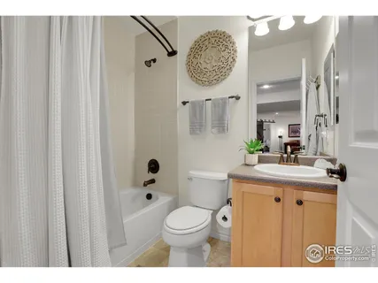 a bathroom with a toilet a sink and a mirror