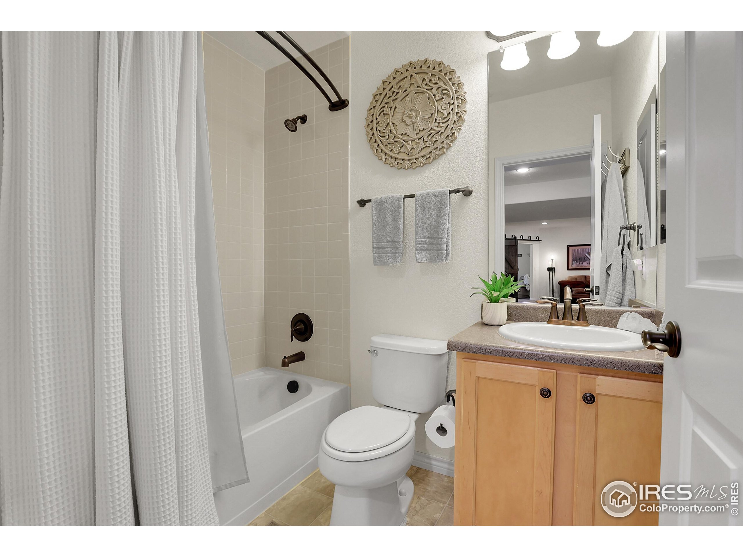 112 Austin Avenue Erie, CO 80516 - Photo 40 of 44 a bathroom with a toilet a sink and a mirror