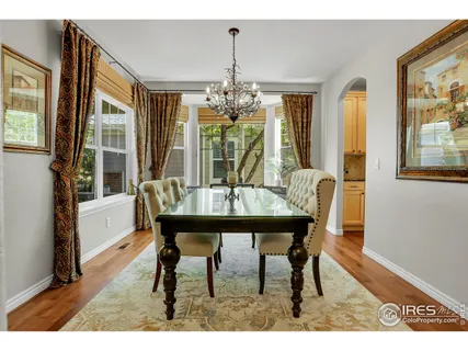 a view of a dining room with furniture wooden floor and chandelier
