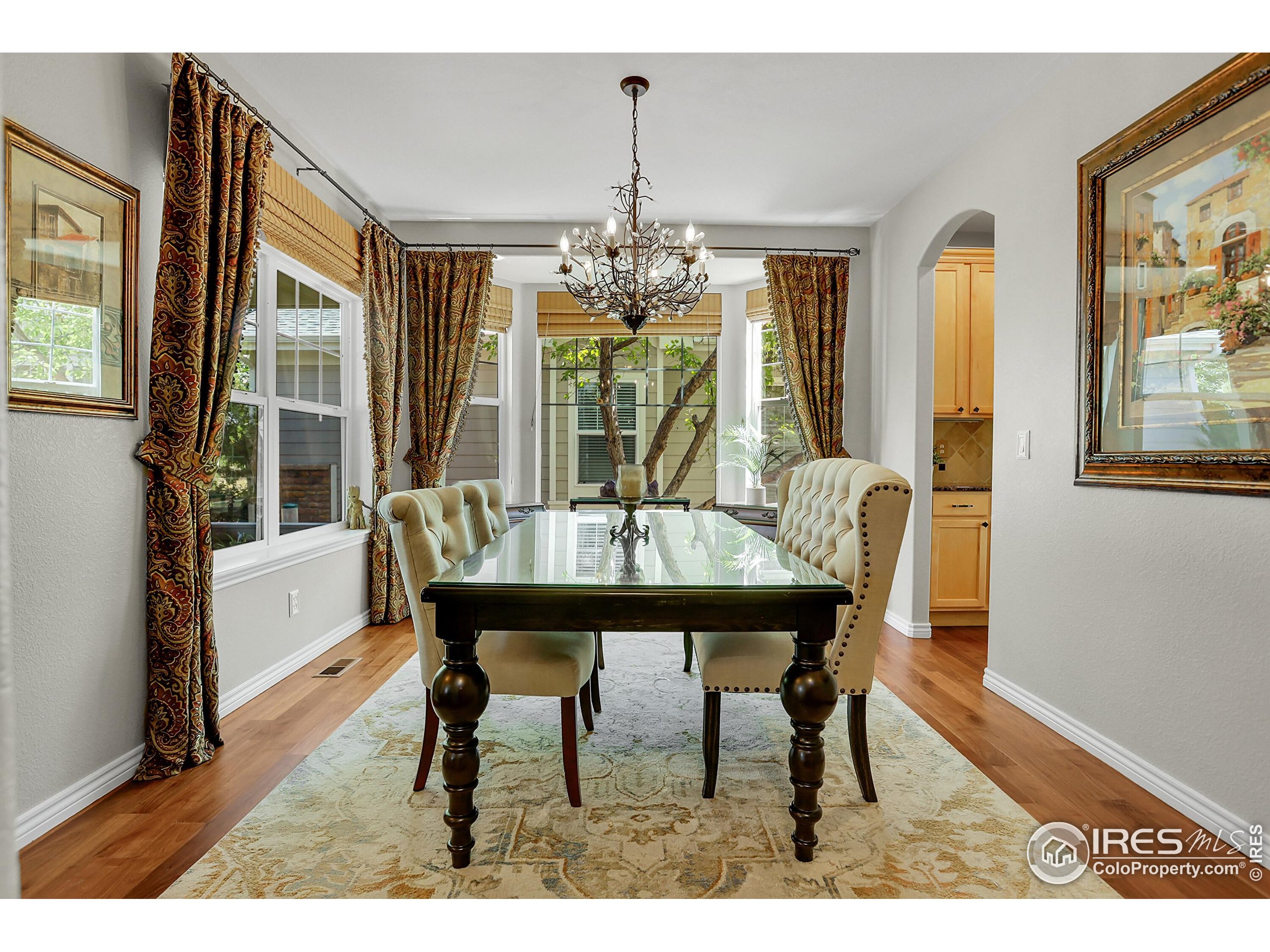 112 Austin Avenue Erie, CO 80516 - Photo 6 of 44 a view of a dining room with furniture wooden floor and chandelier