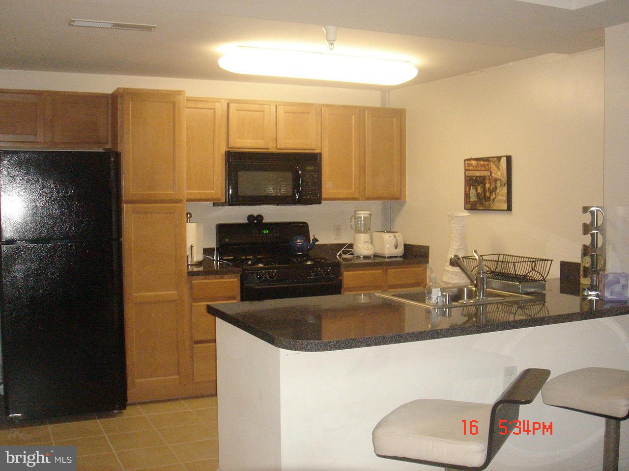 350 G Street Southwest, Unit N403 Washington, DC 20024 - Photo 3 of 5 a kitchen with a refrigerator a stove top oven a sink and dishwasher