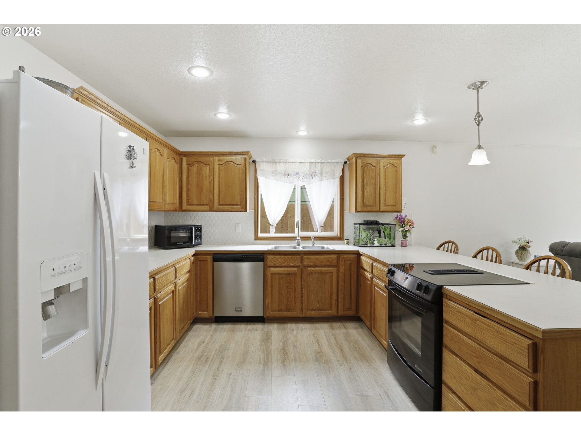 858 Southwest 24th Street Troutdale, OR 97060 - Photo 11 of 32 a kitchen with a sink a refrigerator a stove and wooden floor
