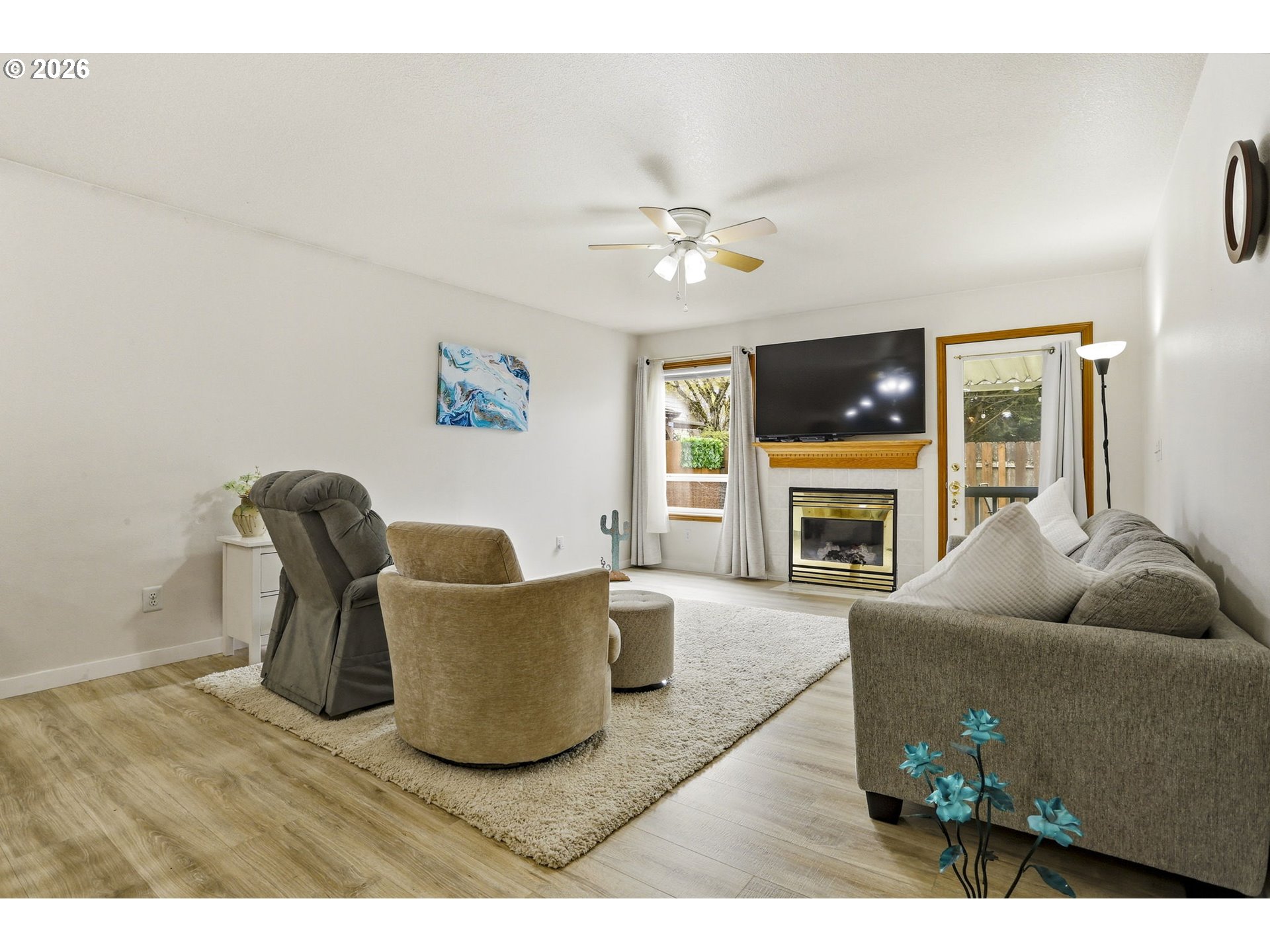 858 Southwest 24th Street Troutdale, OR 97060 - Photo 13 of 32 a living room with furniture a fireplace and a flat screen tv