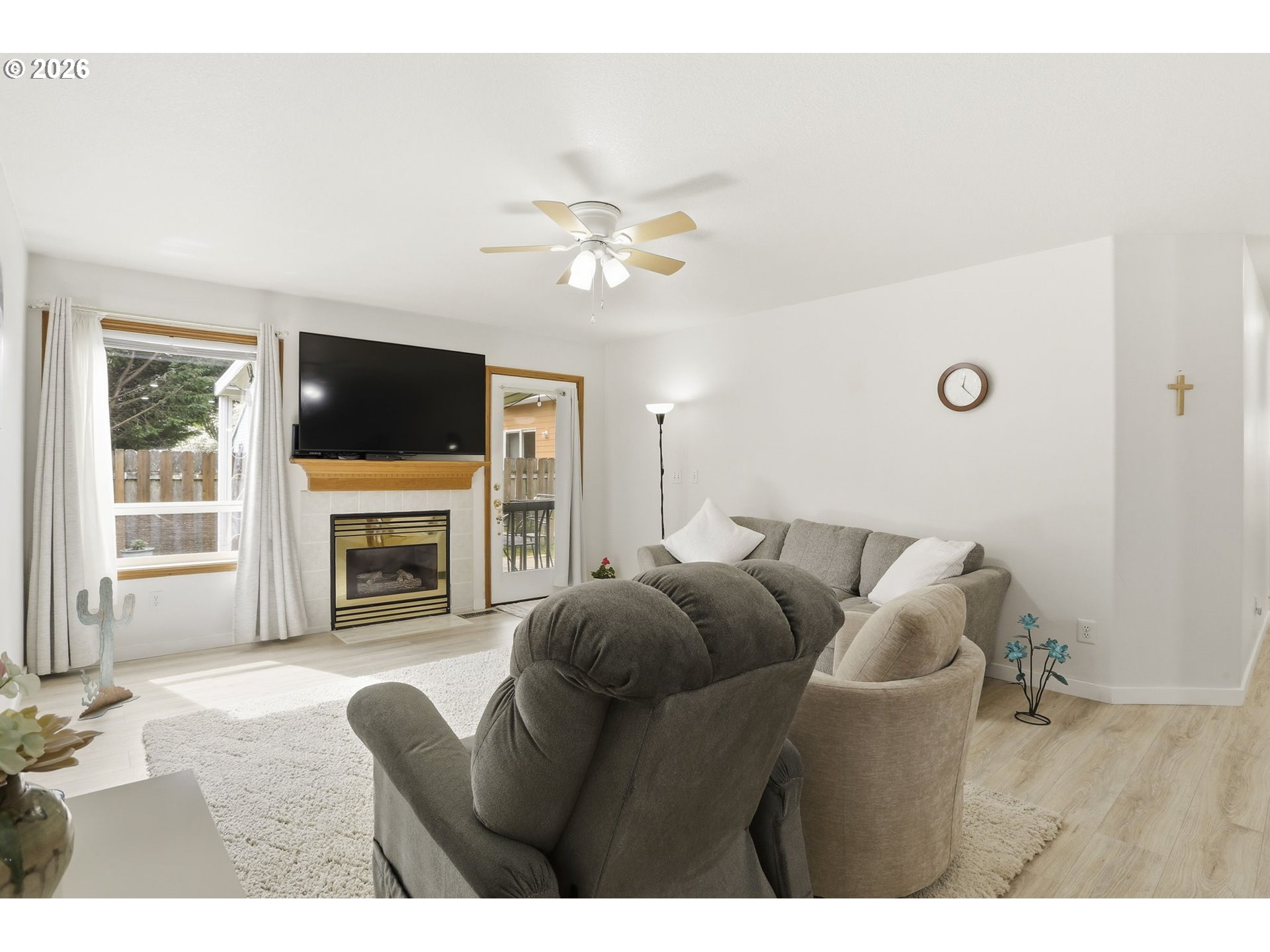858 Southwest 24th Street Troutdale, OR 97060 - Photo 14 of 32 a living room with furniture a fireplace and a flat screen tv