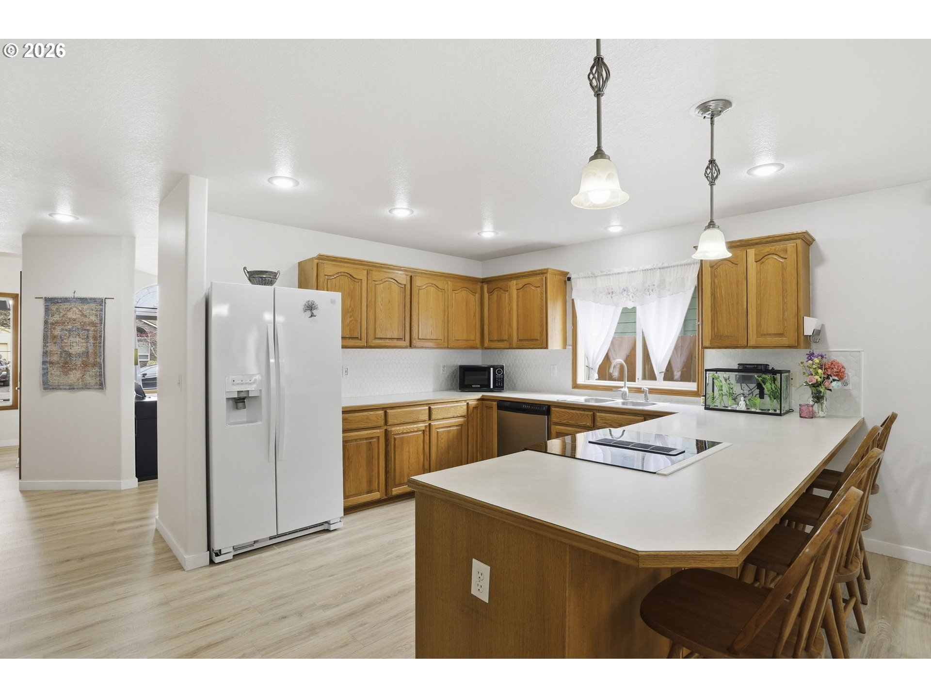 858 Southwest 24th Street Troutdale, OR 97060 - Photo 10 of 32 a kitchen with refrigerator cabinets and wooden floor