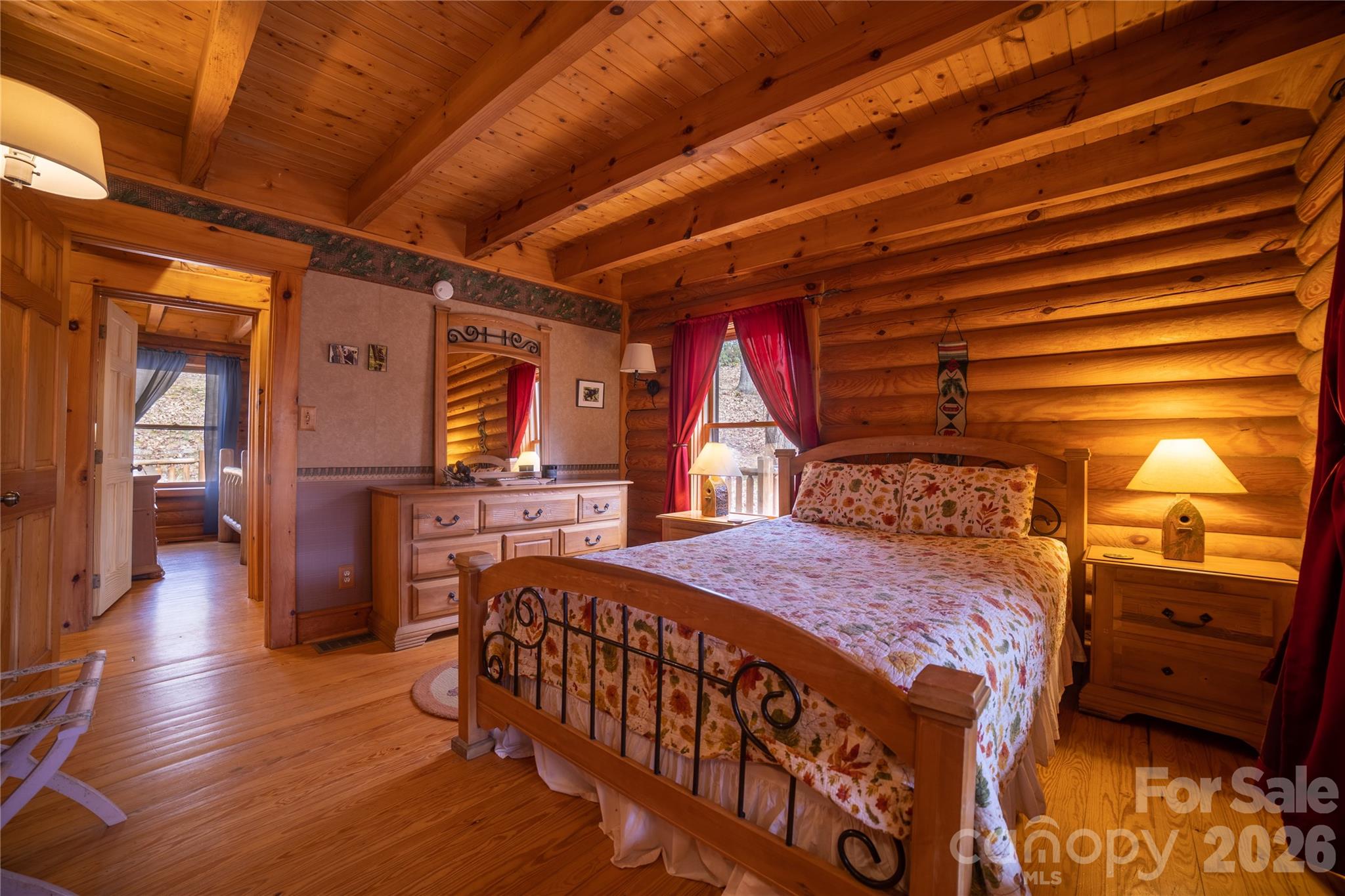682 Rock House Road Hot Springs, NC 28743 - Photo 19 of 43 a bedroom with a bed and wooden floor