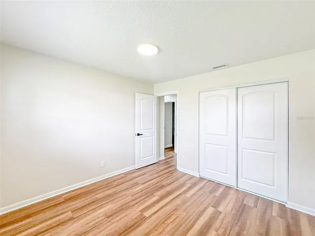 a view of an empty room and wooden floor
