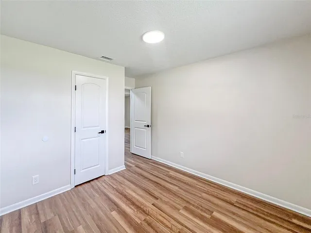a view of an empty room and wooden floor