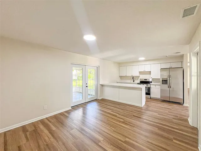 a view of a kitchen with wooden floor