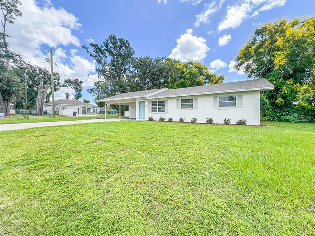 a house view with swimming pool and garden space
