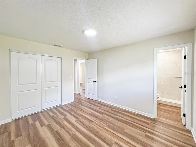 a view of a room with wooden floor