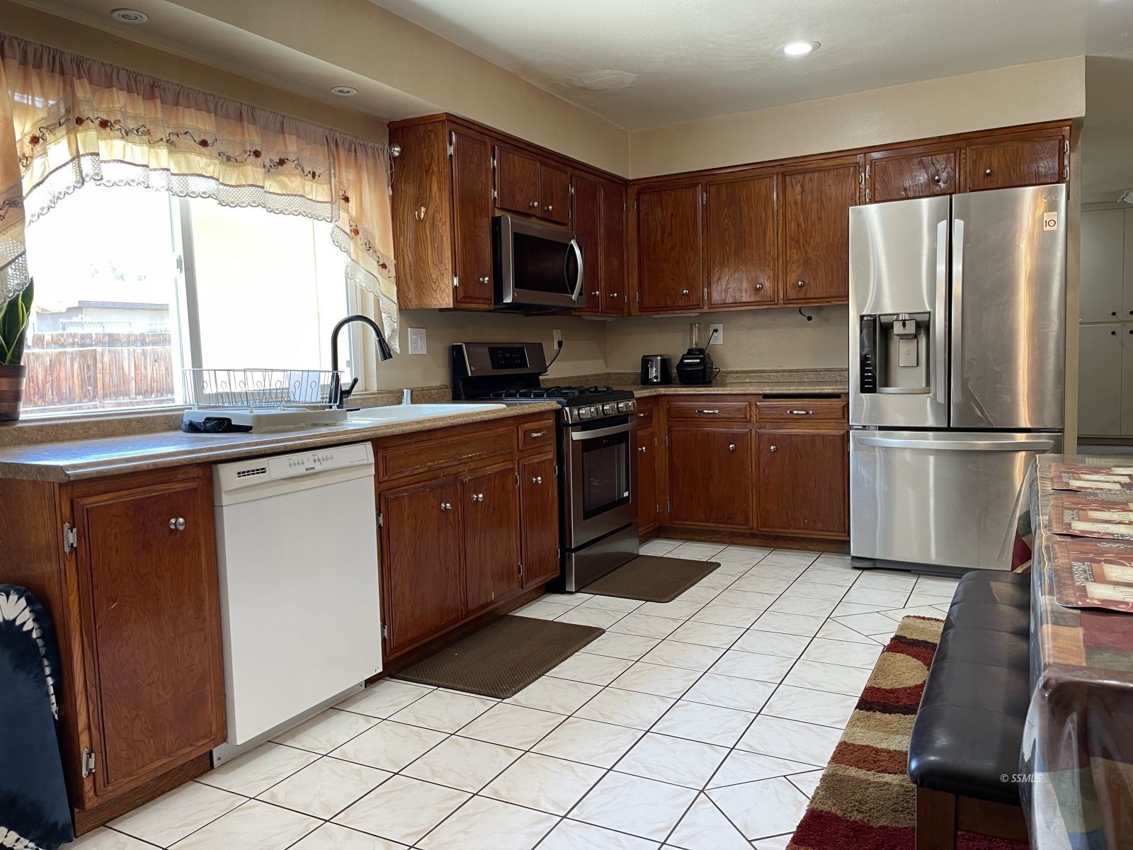 233 West St George Avenue Ridgecrest, CA 93555 - Photo 30 of 47 a kitchen with stainless steel appliances granite countertop a refrigerator sink and stove