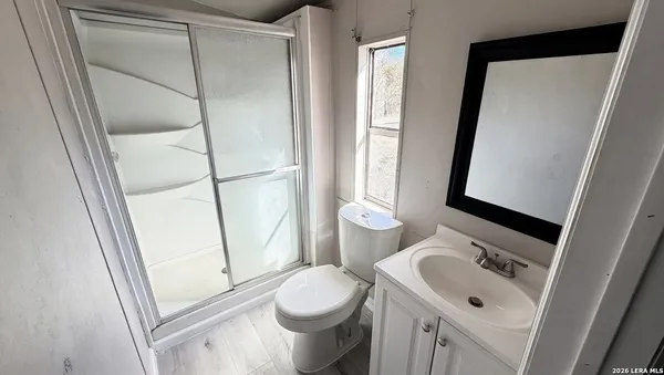 a white toilet sitting next to a bathroom sink