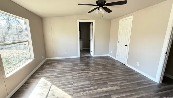 a view of a room with wooden floor and windows