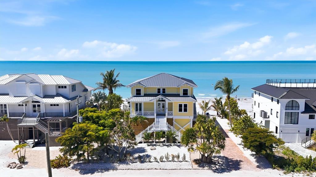 a aerial view of a house with a yard and balcony