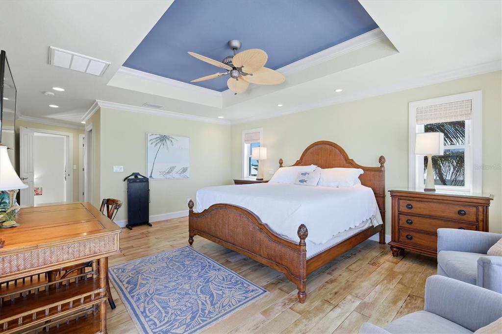 131 South Gulf Boulevard Boca Grande, FL 33921 - Photo 26 of 59 a spacious bedroom with a bed a couch and dresser