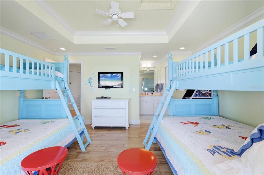 131 South Gulf Boulevard Boca Grande, FL 33921 - Photo 37 of 59 a bedroom with a bed and wooden floor