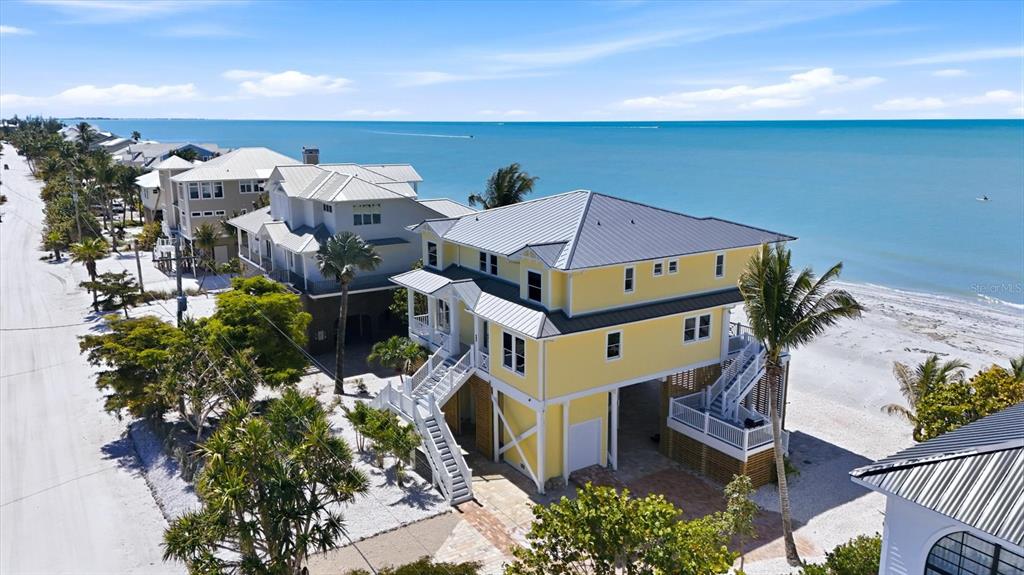 131 South Gulf Boulevard Boca Grande, FL 33921 - Photo 5 of 59 an aerial view of a house with a yard and outdoor seating